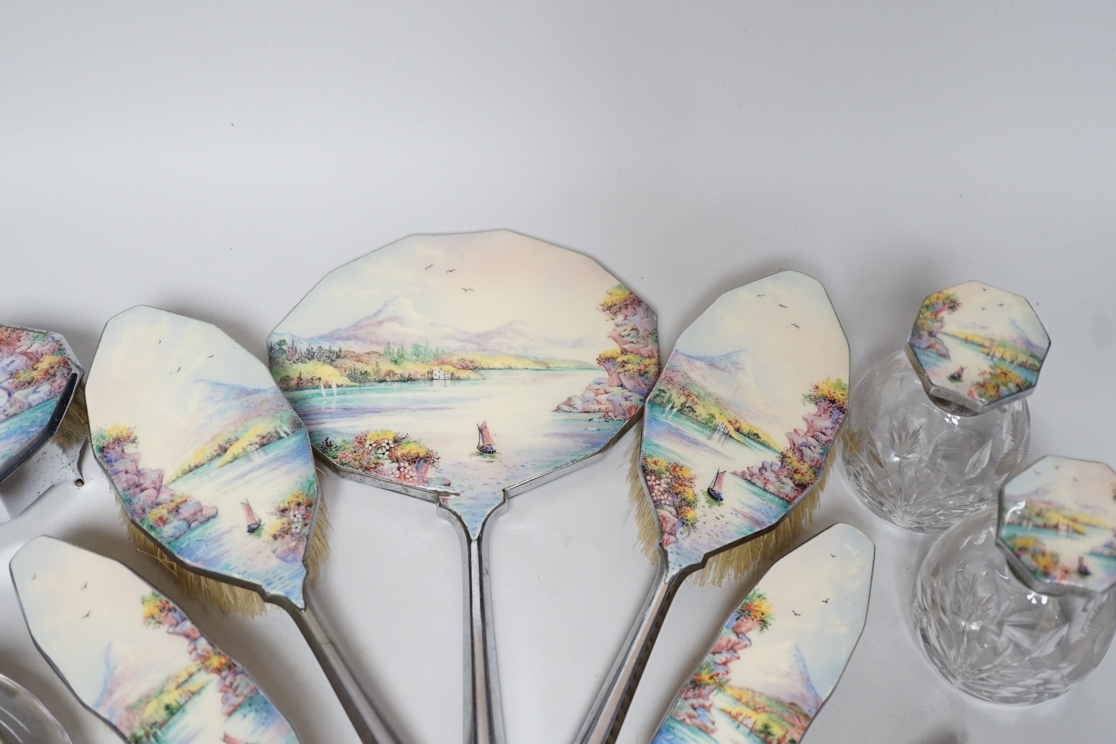 A twelve piece chrome plated and enamel dressing table set